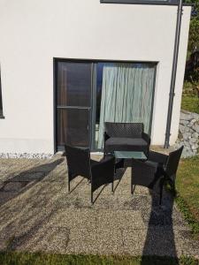a group of chairs and a table in front of a building at 7 Heaven in Eichenberg