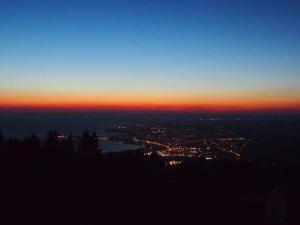 a view of a city at night with the sun setting at 7 Heaven in Eichenberg