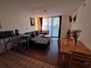 a living room with a couch and a table at 7 Heaven in Eichenberg