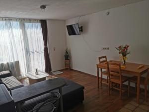 a living room with a table and a dining room at 7 Heaven in Eichenberg
