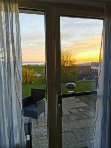 a sliding glass door with a view of a yard at 7 Heaven in Eichenberg