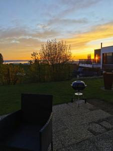 a sunset over a patio with a grill and a table at 7 Heaven in Eichenberg