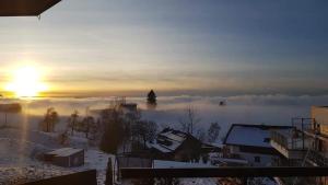 a view of a snowy mountain with the sun in the background at 7 Heaven in Eichenberg