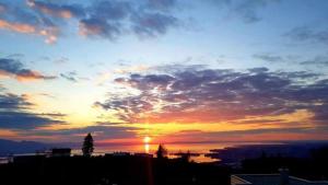 a sunset with the sun setting over a city at 7 Heaven in Eichenberg