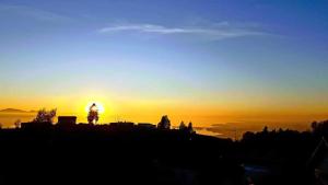 a sunset with the sun setting on the horizon at 7 Heaven in Eichenberg