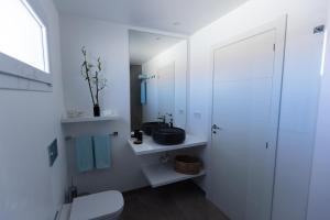 a white bathroom with a sink and a toilet at Island Home Fuerteventura in Corralejo