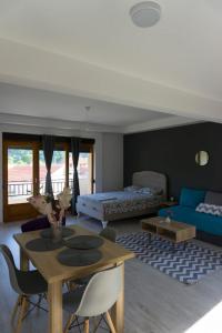 a living room with a table and a couch at Apartments Ena in Trebinje