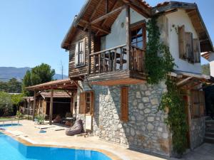 a villa with a swimming pool and a house at Olympos Koyevi Countryhouse in Olympos