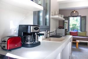 a kitchen with a coffee maker on a counter at Orkeli casa in Plaka