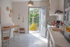 a kitchen with a door leading to a garden at Orkeli casa in Plaka
