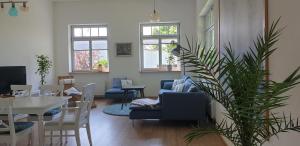 a living room with a blue couch and a table at Fliederhaus Dresden in Dresden