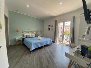 a bedroom with a blue bed and a window at La Piccola Formica Charme Rooms in Palermo