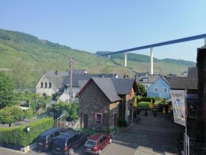 a small town with cars parked in a parking lot at Gästehaus Herbert Kappes in Zeltingen-Rachtig