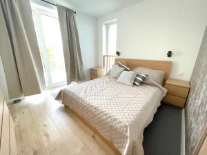 a bedroom with a bed and a large window at Apartmán Vila Zuberec in Zuberec +85 photos