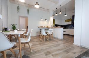 a kitchen and dining room with a table and chairs at Palazzo Lombardi Al Vicolo in Sassari