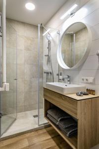 a bathroom with a sink and a shower at Rusnės Perlo apartamentai in Rusnė +140 photos
