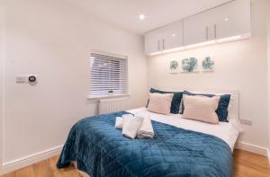 a bedroom with a large bed with blue blanket at Henry Court Apartment 1 in York