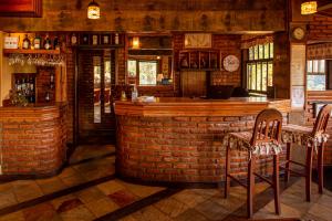 a bar in a restaurant with a brick wall at Pousada Monte Imperial in Petrópolis
