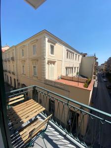 a balcony with a table and benches on a building at Le stanze dei desideri in Caserta