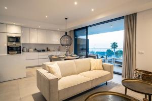 a living room with a couch and a kitchen at Sealine luxury apartment in Torrox Costa in Torrox Costa