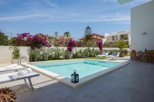 a swimming pool in the middle of a yard at Villa Ulivo - IsulaTravel in Marzamemi +13 photos