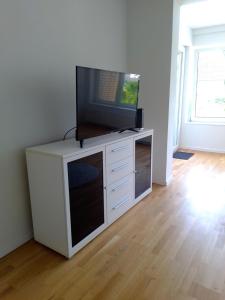 a flat screen tv on a white entertainment center at Ruhige zentrale Lage in Bad Honnef in Bad Honnef am Rhein