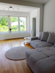 a living room with a couch and a large window at Ruhige zentrale Lage in Bad Honnef in Bad Honnef am Rhein