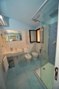 a bathroom with a shower and a sink and a toilet at Casa Campanella Resort in Capoliveri