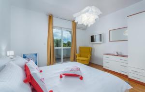 a bedroom with a large white bed with a yellow chair at Villa Palma Selina in Selina +22 photos