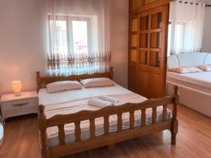 a small bedroom with a bed and a tub at Guest house Naser in Ulcinj