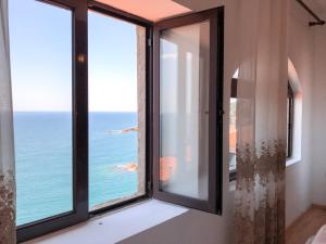 a room with a window with a view of the ocean at Guest house Naser in Ulcinj
