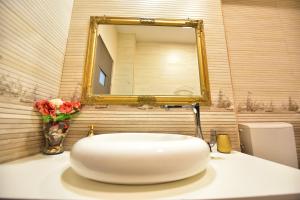 a white sink in a bathroom with a mirror at FLH - Mountain View Apartment in Sibiu +12 photos
