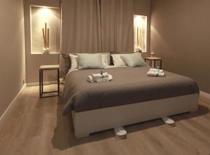a bedroom with a large bed with two towels on it at ACQUACHIARA ISEO CENTER BED AND BREAKFAST villa with PARKING inside Foresteria in Iseo