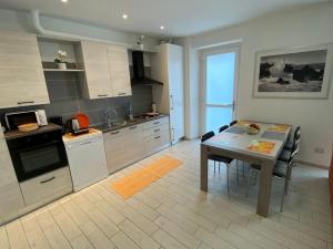 a kitchen with a table and a dining room at Canada in Stresa