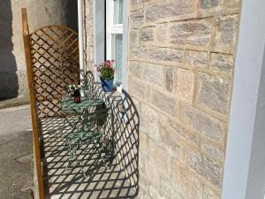 a patio with a table and a brick wall at Canada in Stresa
