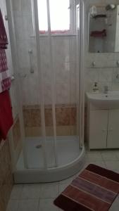 a bathroom with a shower and a sink at Ágnes Villa in Zalakaros
