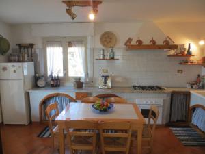 a kitchen with a table with a bowl of fruit on it at Villa Panoramica in Valderice