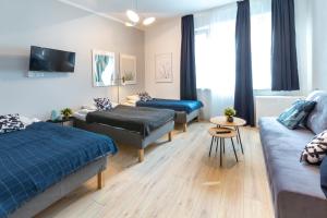 a living room with two beds and a couch at Wonderful Apartments in the Center of Krakow in Kraków