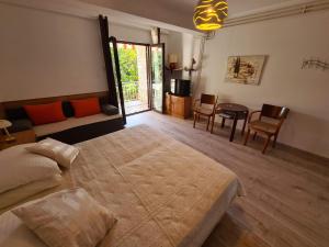 a bedroom with a large bed and a living room at Apartments Ana in Medulin