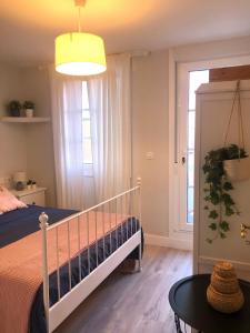 a bedroom with a bed and a table and a window at Casa Casco Antiguo A Guarda in A Guarda