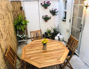 a wooden table with chairs and flowers on a patio at Casa Casco Antiguo A Guarda in A Guarda