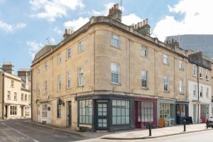an old brick building on the corner of a street at Monmouth Street Bath in Bath
