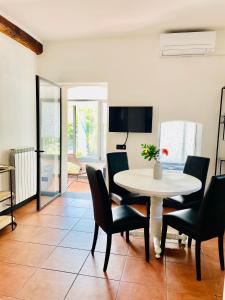 une salle à manger avec une table et des chaises blanches dans l'établissement La casa di Giulia Apartment with air conditioning, wifi and private parking, à Rapallo