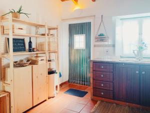 a kitchen with a counter and a sink and a window at Casa da Vila in Odeceixe