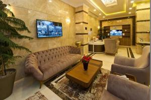 a living room with a couch and a table at Delights Inn - Green Oasis Hotel in Al Madinah