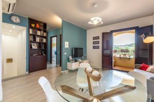 a living room with a glass table and white chairs at Casa Vacanze Raggio di Luna in Villasimius