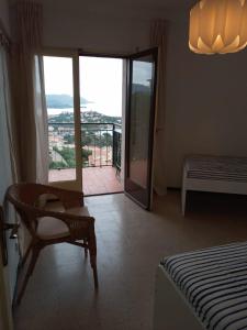 een slaapkamer met een bed en een stoel en een balkon bij Apartamento con vista al mar in Llança