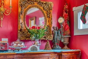 a mirror sitting on top of a dresser with flowers at Mountain Treasure Bed and Breakfast in Maplecrest