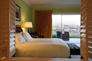 a bedroom with a large bed and a large window at The Yeatman in Vila Nova de Gaia