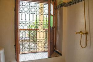 a bathroom with an open door to a shower at Riad Dar Tamlil in Marrakesh